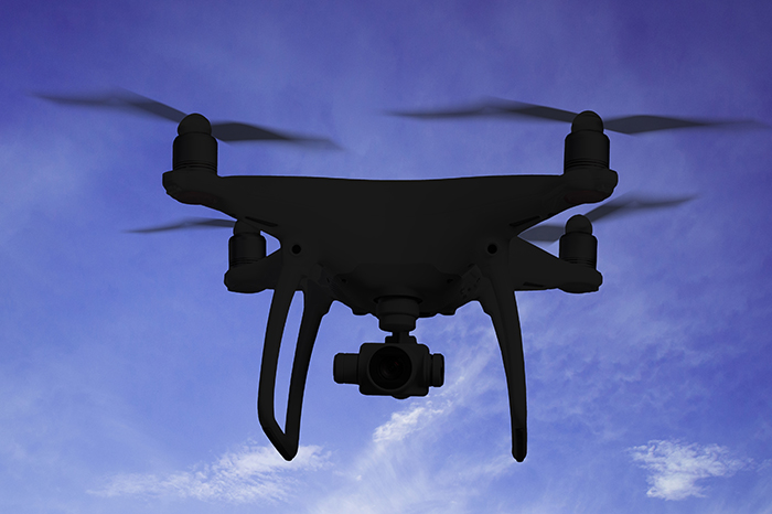 Silhouette Of Hovering Drone Taking Pictures Of Nature At Dusk